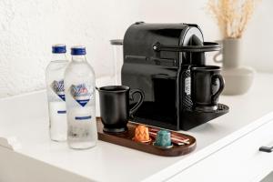 a coffee maker and two bottles of milk on a counter at Sandal Alaçatı - Adult Only in Alaçatı