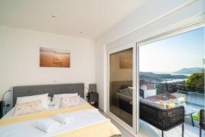 a bedroom with a bed and a large window at Dubrovnik Icy Guest House in Dubrovnik