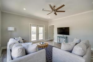 a living room with two couches and a ceiling fan at Pet-Friendly Vacation Rental in Biloxi Near Beach! in Biloxi