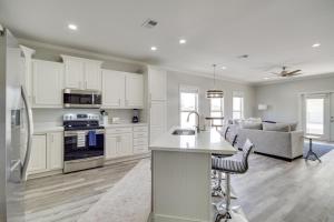 a kitchen and living room with white cabinets at Pet-Friendly Vacation Rental in Biloxi Near Beach! in Biloxi