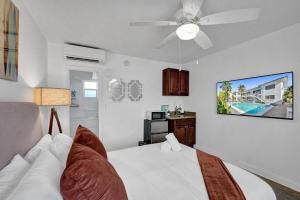 a bedroom with a white bed with a ceiling fan at Waves On Desoto Lovely Studio # 2 in Hollywood