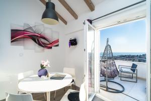 a room with a white table and chairs and a balcony at Dubrovnik Icy Guest House in Dubrovnik