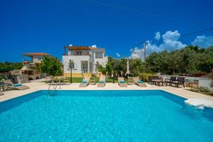 a swimming pool in front of a villa at Villa Erasmia- House 1 ground floor in Sarláta