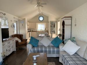 a living room with a couch and a kitchen at Blue Bay at The Bay Filey, sleeps 4-6, 2 dogs welcome for free too in Filey