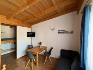 a small living room with a wooden table and chairs at Klütz Garden Apartment in Klütz