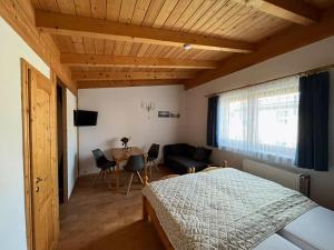 a bedroom with a bed and a table and a couch at Klütz Garden Apartment in Klütz