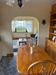 a dining room with a table and chairs and a mirror at Moriarty’s in Kenmare