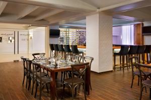 a dining room with a table with wine glasses at The Gunter Hotel San Antonio Riverwalk in San Antonio