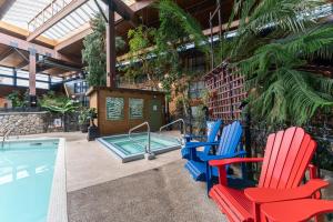 a group of chairs and a swimming pool at Prestige Vernon Lodge in Vernon