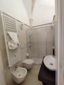 a bathroom with a shower and a toilet and a sink at ROSSINI GUEST HOUSE in Martina Franca