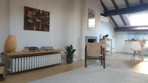 a living room with a radiator and a chair at Mansarda Laurent in Parma