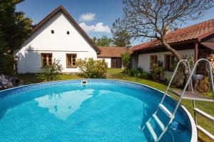 a swimming pool in front of a house at Chalupa Kámen in Pacov