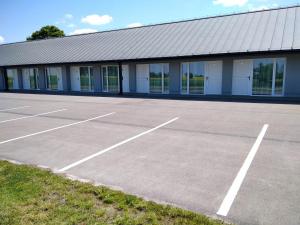 an empty parking lot in front of a building at Motel Express in Bogucin