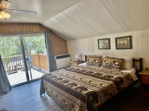 a bedroom with a large bed and a balcony at Bear Creek Resort in Big Bear Lake +251 photos