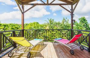 a deck with two chairs and a gazebo at Sunshine Villa in Le Moule