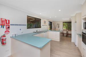 cocina con encimera azul en una habitación en Hibiscus 8, en Forster