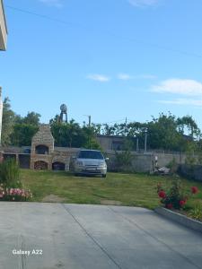 a car parked in the yard of a house at Elite Inn in Vlorë