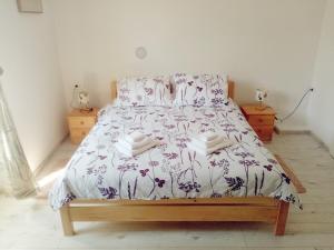 a bedroom with a bed with a floral bedspread at San Eleuterio Guesthouse in Poreč