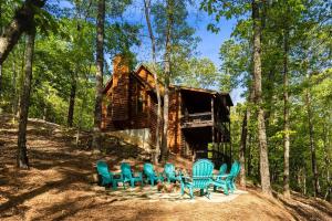 a group of blue chairs in front of a cabin at Luxe Family Cabin 8 min to Downtown Blue Ridge in Blue Ridge