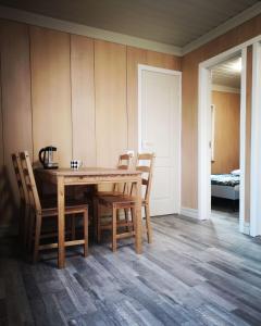 a dining room with a wooden table and chairs at Atostogu nameliai prie Palangos 