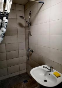 a bathroom with a sink and a shower at Atostogu nameliai prie Palangos 