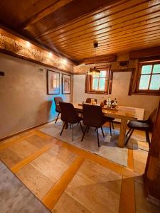 a dining room with a wooden table and chairs at Zlatibor Resort & Spa in Zlatibor