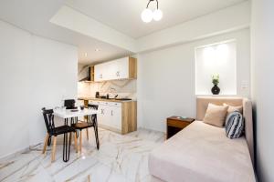 ein Schlafzimmer mit Bett und Tisch und eine Küche in der Unterkunft Studios Passa in Limenaria
