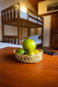 a basket of limes sitting on a table at Brisas del Río in Mindo