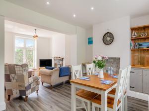 a dining room and living room with a table and chairs at Happy House in Bevendean