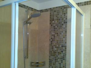 a shower with a glass door in a bathroom at Virtus Et Otium - Feldererhof in Vipiteno +23 photos