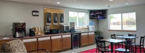 a kitchen with a counter and a table and chairs at Rodeway Inn & Suites North Sioux City I-29 in North Sioux City