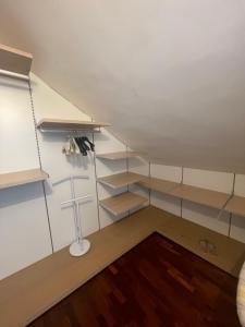 a room with shelves and a cross on the wall at Sunnyhouse in Santa Margherita Ligure