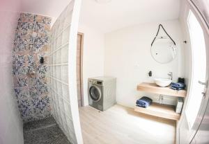 a bathroom with a washing machine and a sink at Villa Yanna in Benalmádena