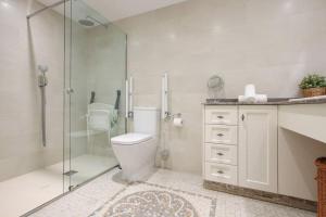 a bathroom with a toilet and a glass shower at Marina Bay by Asola Property in Estepona +9 photos