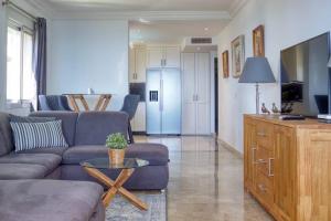 a living room with a couch and a table at Marina Bay by Asola Property in Estepona