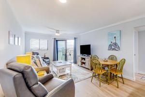 a living room with a couch and a table at Bay Creek Villa - 304 in Edisto Island