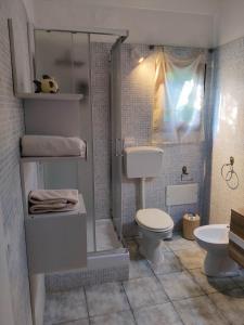 a bathroom with a toilet and a shower and a sink at Il Giardino su Lido Burrone in Favignana