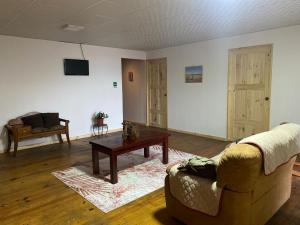 a living room with a couch and a coffee table at Hostal Dilu Boquete in Bajo Boquete