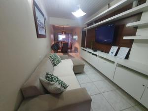 a living room with a couch and a tv at Casa 3quartos rota Maragogi Carneiros in São José da Coroa Grande