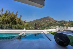 a swimming pool with a mountain in the background at Troy Hill in Los Angeles
