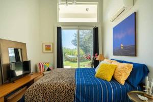 a bedroom with a bed and a television and a window at Troy Hill in Los Angeles +92 photos