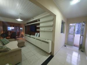 a living room with a couch and a tv at Casa 3quartos rota Maragogi Carneiros in São José da Coroa Grande