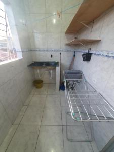 a bathroom with a sink and a tiled floor at Casa 3quartos rota Maragogi Carneiros in São José da Coroa Grande