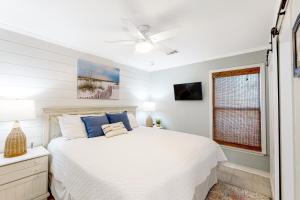 a bedroom with a white bed and a window at Sugar Sand Oasis in Santa Rosa Beach +16 photos