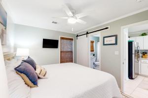 a bedroom with a white bed and a ceiling fan at Sugar Sand Oasis in Santa Rosa Beach