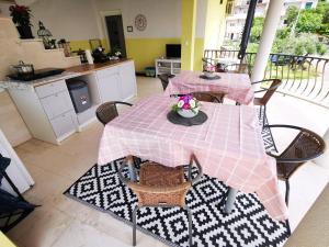 a table with a pink table cloth on it in a kitchen at Villa Dalma in Tučepi