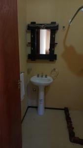 a bathroom with a white sink and a mirror at El Convento de Tilcara in Tilcara