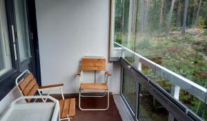 a room with a chair and a desk and a window at 21 minutes from Helsinki city - larger room in Kauniainen