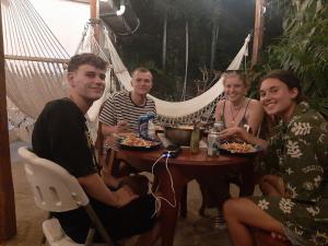 a group of people sitting around a table in a hammock at Casa de Gio in Moyogalpa +38 photos