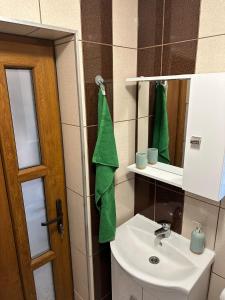 a bathroom with a sink and a mirror at Tiny Traditional House in Bucharest